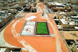 Aerial record of Alhamra Park on completion: planting established and fenced sports pitch installed